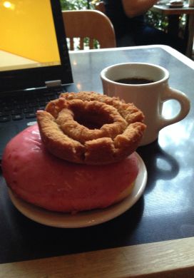 The tools of a food blogger's craft: doughnuts, coffee, and a laptop