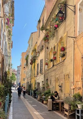 Narrow street with flowers in window baskets 