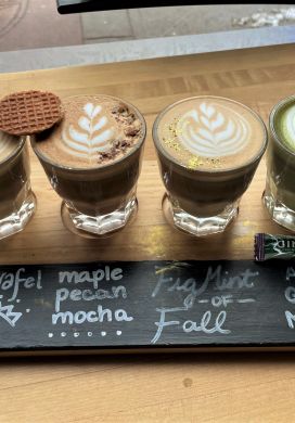 Four glasses of coffee with latte art