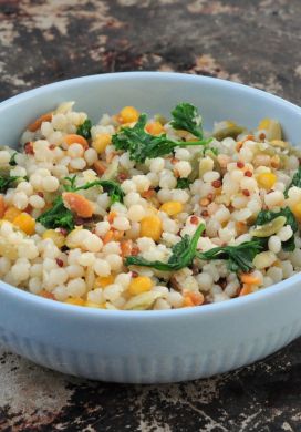 Bowl filled with cooked Harvest Grains Blend with parsley and grated parmesan