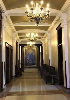 Hallway with crystal chandeliers and oil painting
