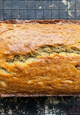 Top down view of a loaf of banana bread on a wire rack