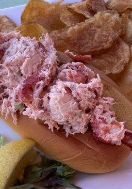 Lobster roll on a plate with kettle chips
