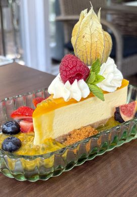 Cheesecake surround by fresh fruit garnishes