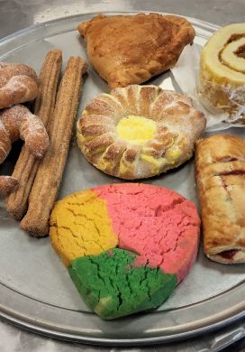 Round metal tray with an assortment of colorful Mexican pastries, Pastries Michoacan Bakery Kansas City Kansas