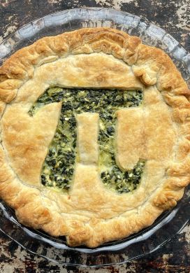 Spinach feta pie with a pi symbol cut out of the top crust