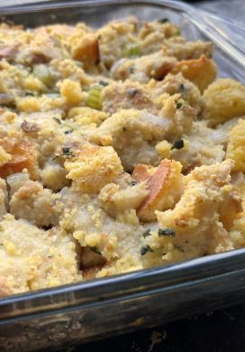 Stuffing made with white bread and corn bread in a glass baking dish