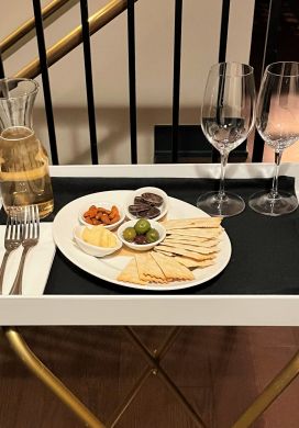 Tray with wine glasses, carafe of white wine, and tray of antipasti