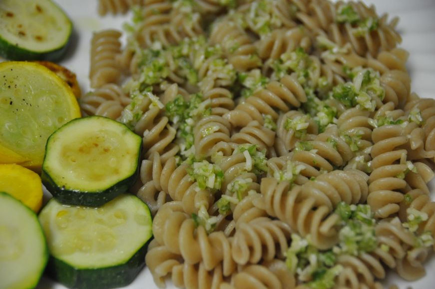Plate of rotini topped with garlic scape pesto