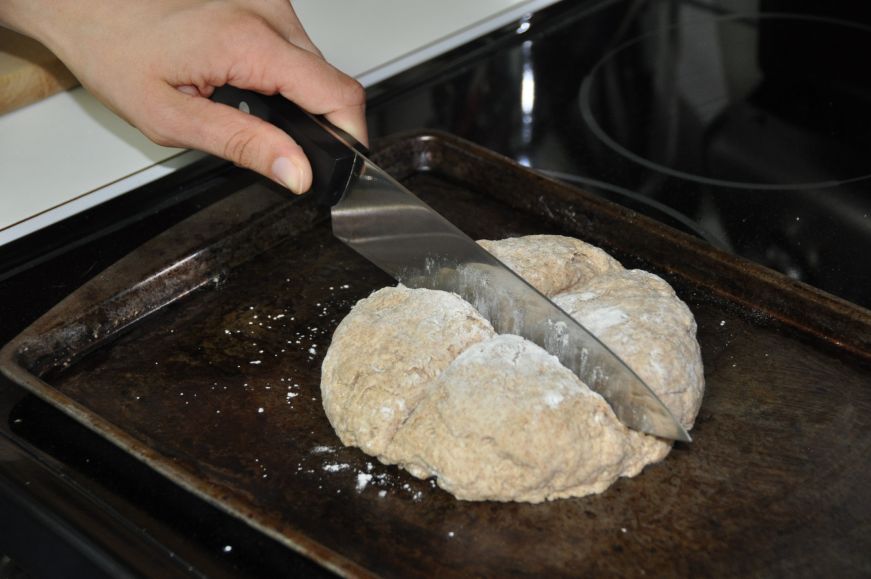 Cutting Cross into Irish Soda Bread 