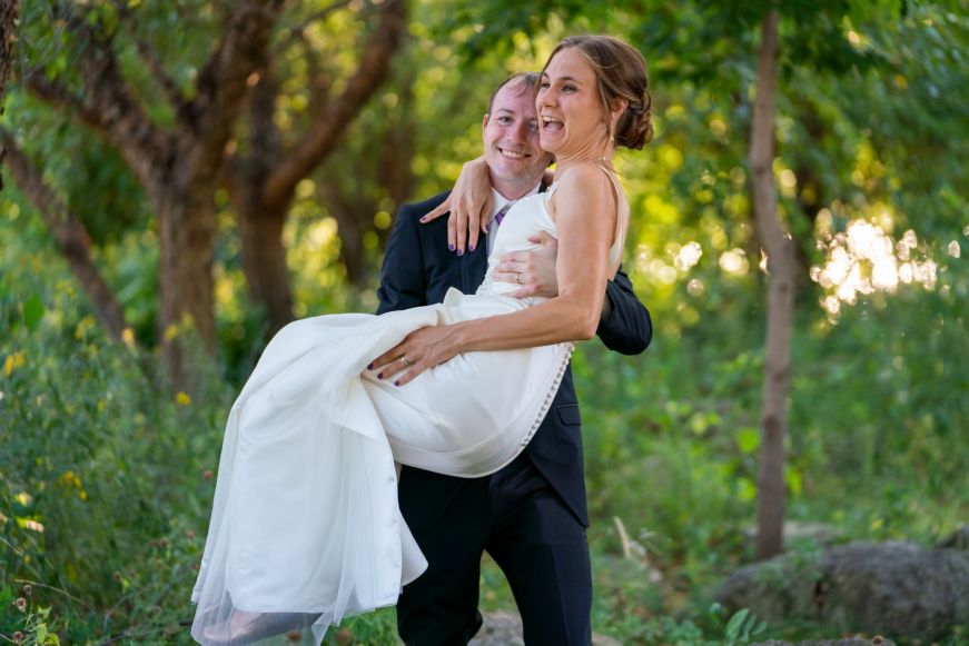 Stacy laughing while Mike carries her