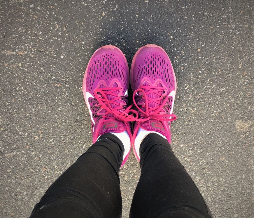 Stacy's feet in magenta running shoes