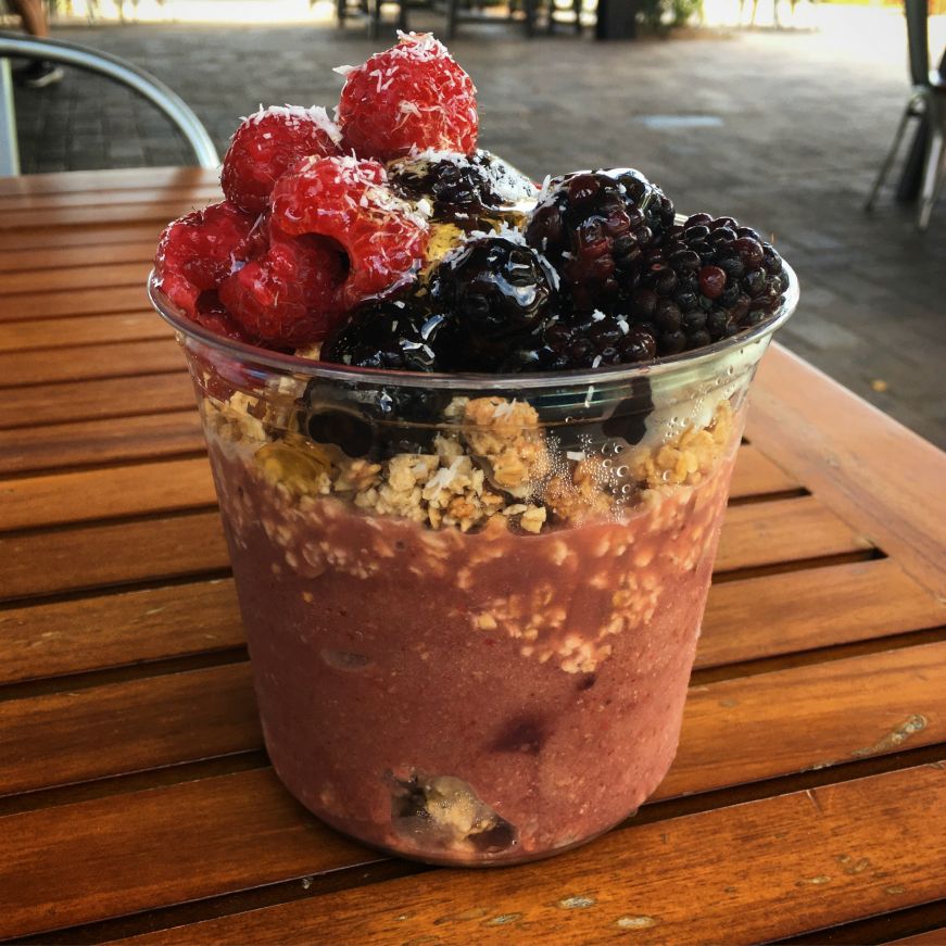 Acai bowl topped with fresh berries sitting on a wooden table, Sparkman Wharf, Tampa