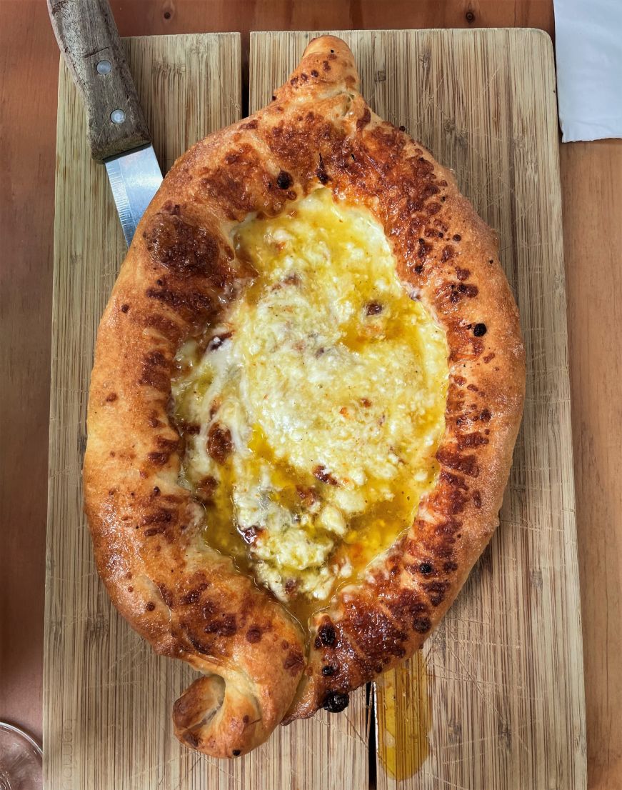 Top down view of an oval bread filled with cheese