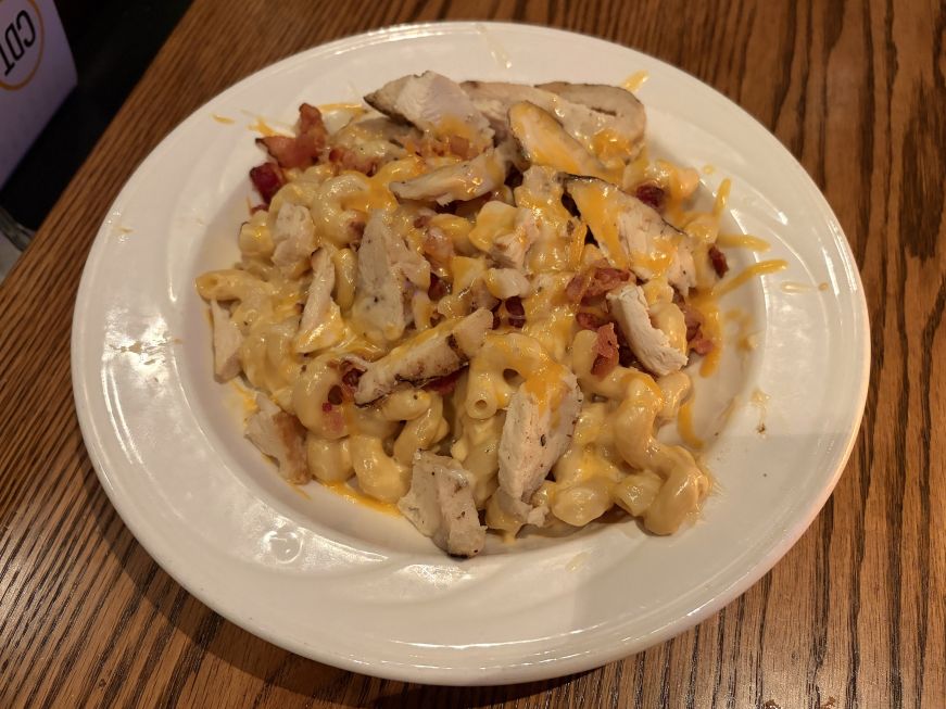 Bowl of cavatappi noodles tossed with Velveeta and topped with chicken breast pieces