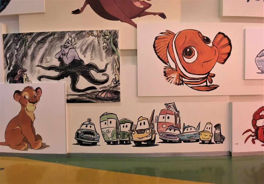 Wall decorated with drawings depicting Disney characters, Art of Animation Resort lobby