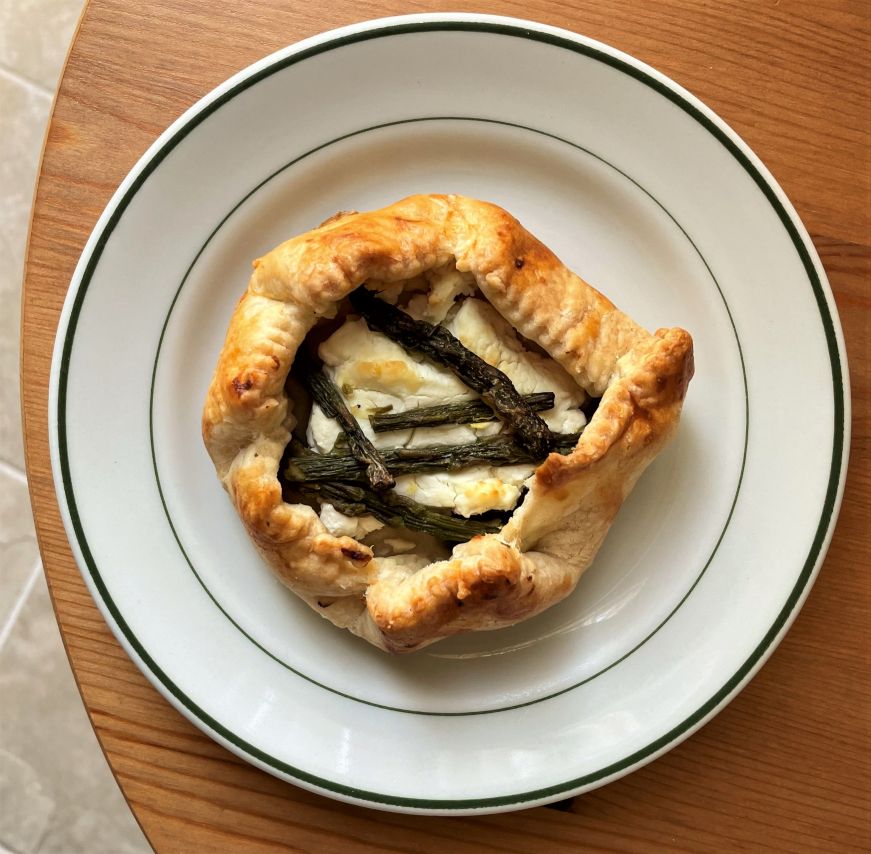 Asparagus chevre galette, Fruit and Grain Bakery Personal-sized galette pastry filled with goat cheese and topped with small asparagus spears