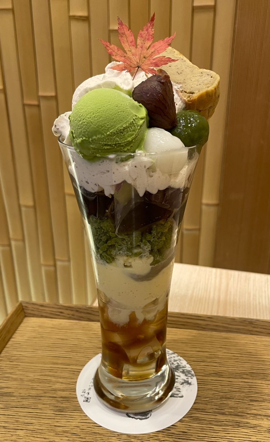 Parfait of cake, ice cream, and jellies topped with a maple leaf