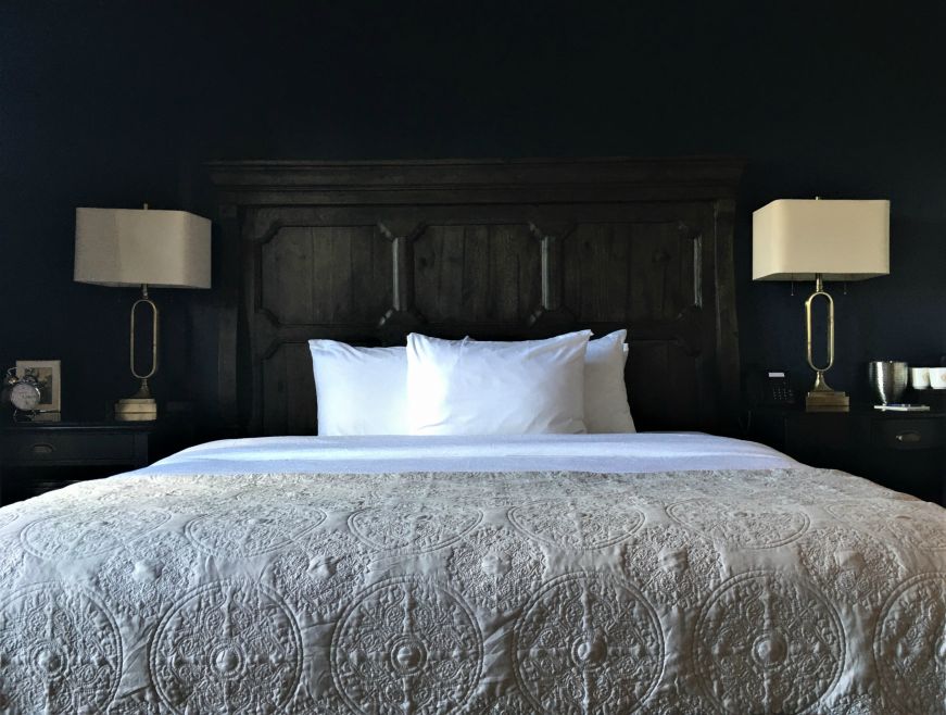 Bed with an elaborate wooden headboard