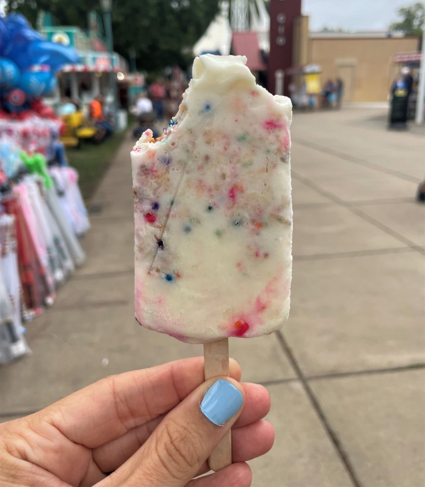 Birthday cake paleta from Hamline Dining Hall at the Minnesota State Fair Hand holding birthday cake paleta