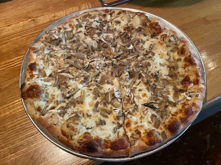 Pizza topped with oyster mushrooms, garlic, and rosemary