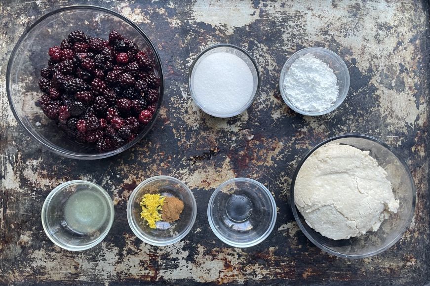 Blackberry pie ingredients arranged on a baking sheet