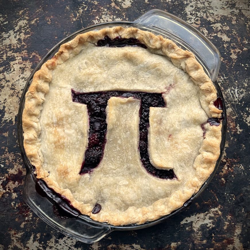 Two-crust blackberry pie with a pi symbol cut into the top crust