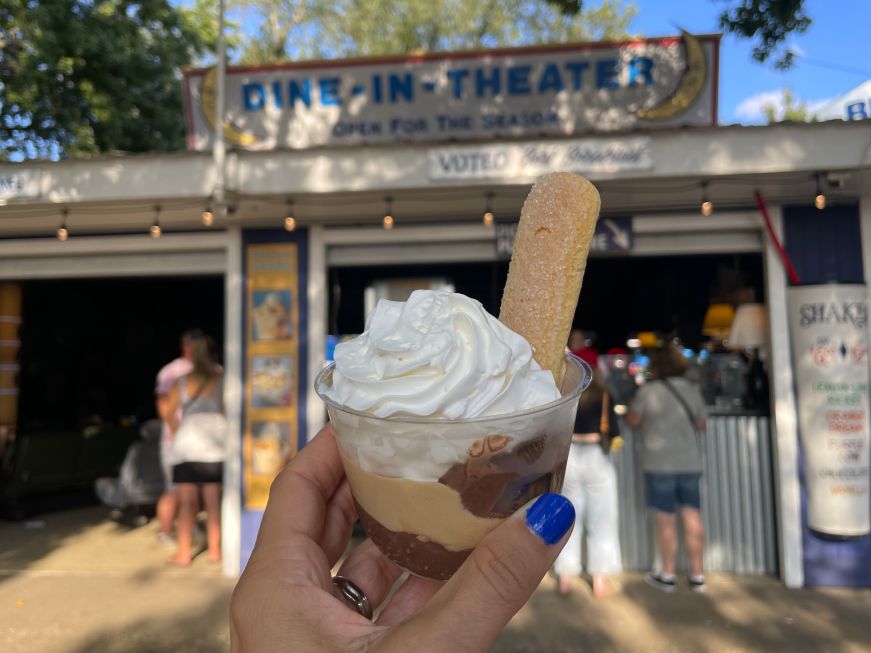 Frozen fudge affogato, Blue Moon Dine In Cafe, Minnesota State Fair Stacy's hand holding an ice cream sundae in front of the Blue Moon Dine In sign
