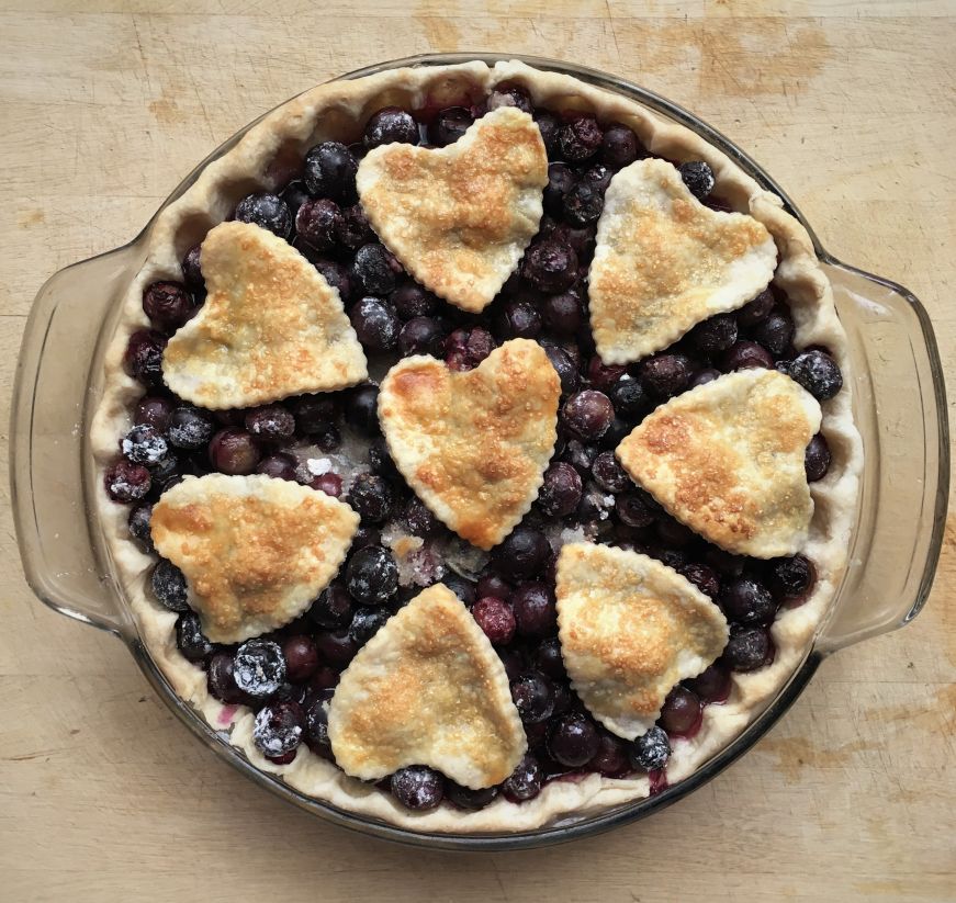 Blueberry pie topped with heart-shaped pieces of crust