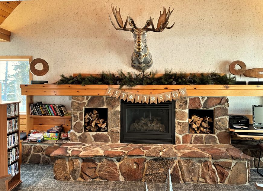 Fireplace with a mounted moose head 