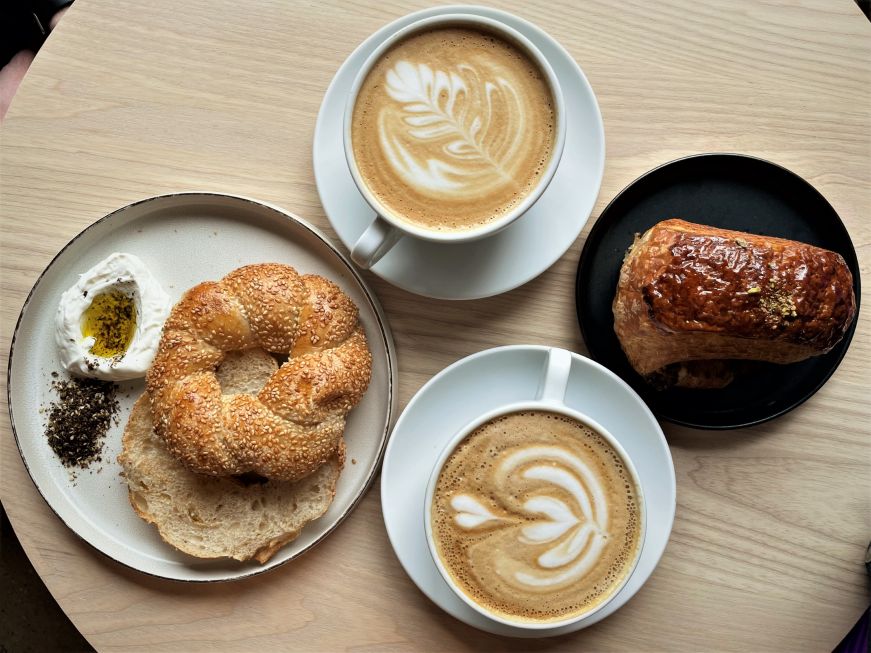 Top down view of pastries and coffee arranged on table