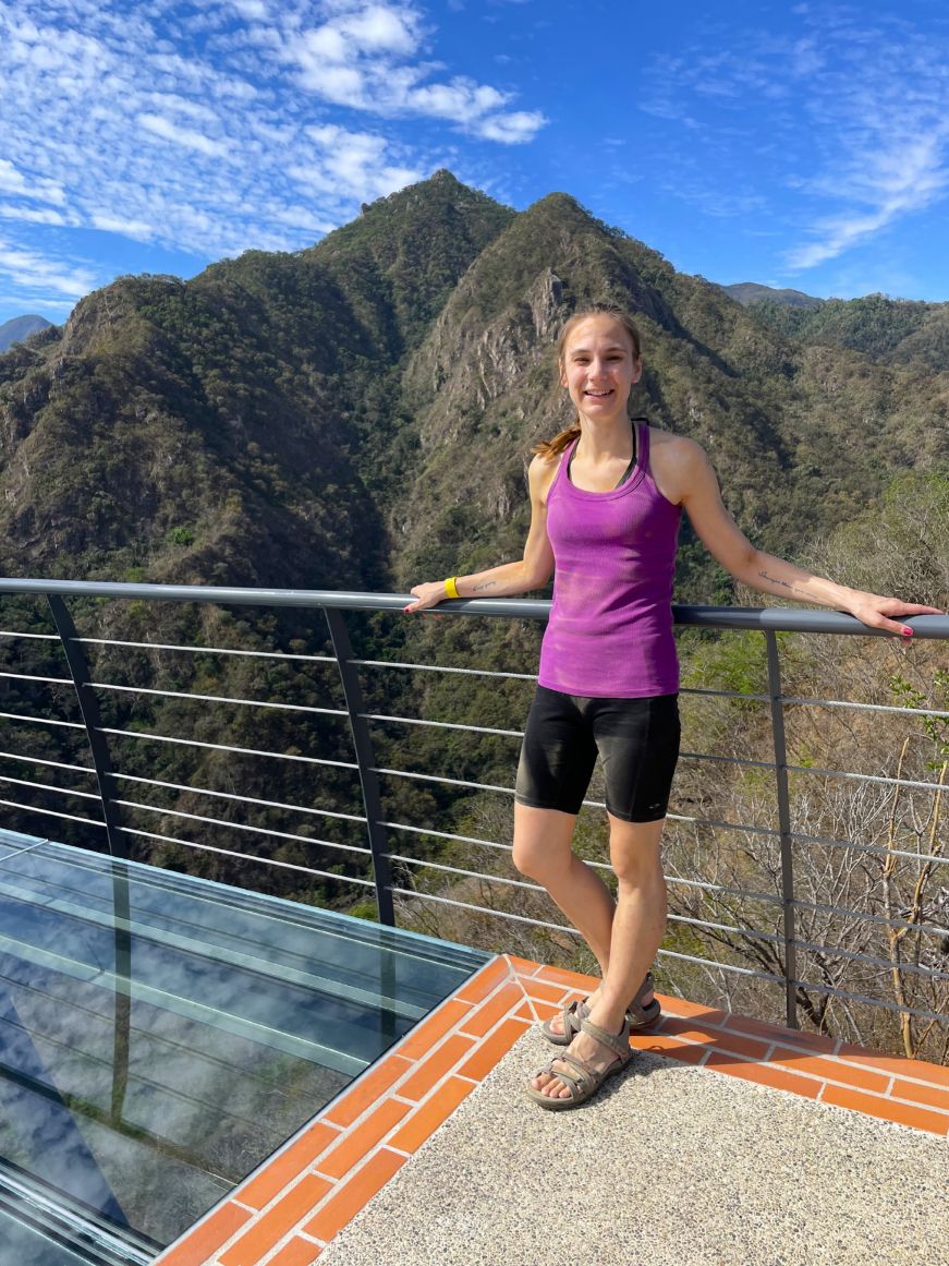 Mountain views at Canopy River Adventure Park in Puerto Vallarta, Mexico Stacy standing on a glass platform with mountains in the background