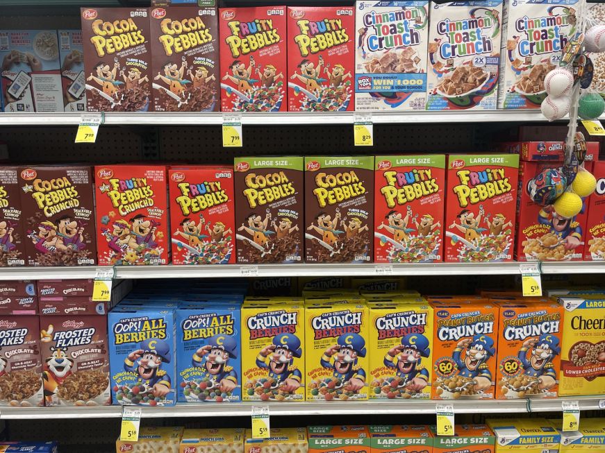 Grocery store shelves stocked with breakfast cereal