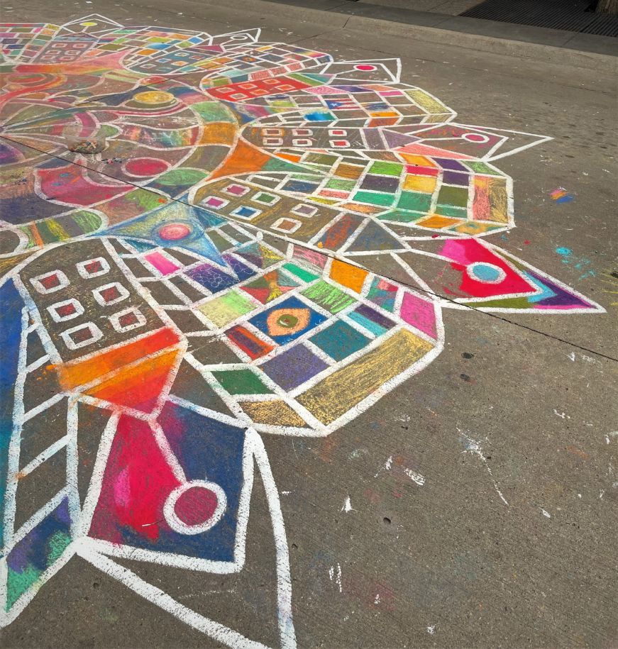Colorful chalk art mandala on pavement