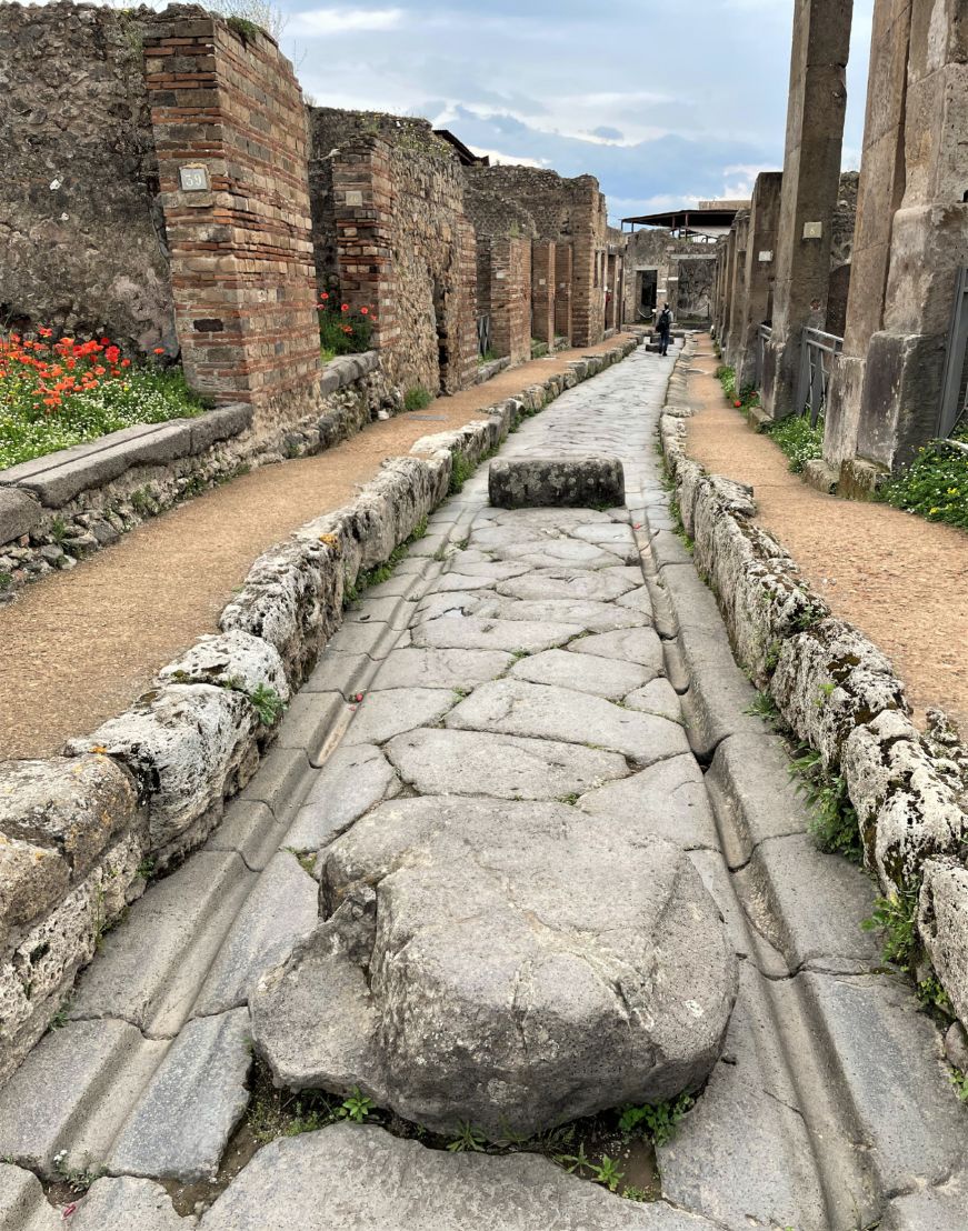 Chariot grooves in Pompeii street Cobblestone street with grooves worn into it