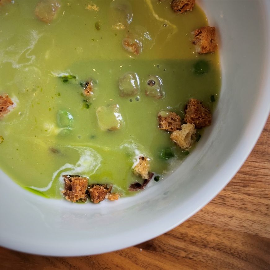 Chilled sweet pea soup, Alma Bright green soup garnished with tiny croutons