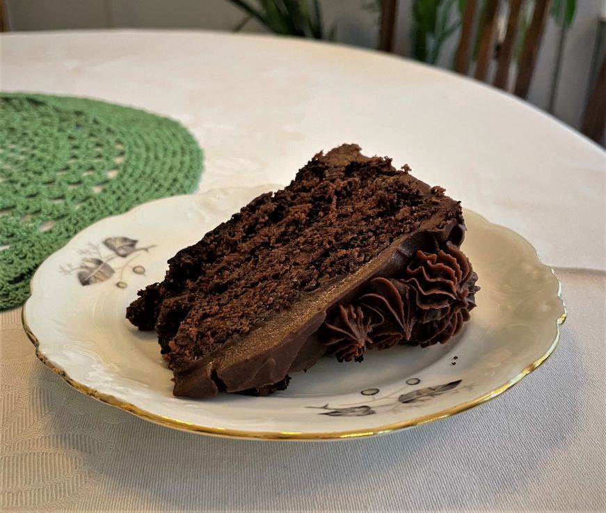 Slice of chocolate cake on a china plate