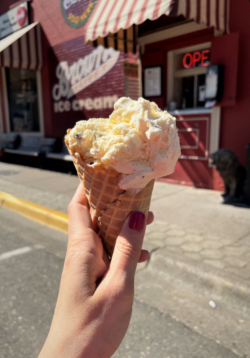 Chocolate chip cookie dough ice cream cone, Leo's Grill & Malt Shop Hand holding chocolate chip cookie dough ice cream cone
