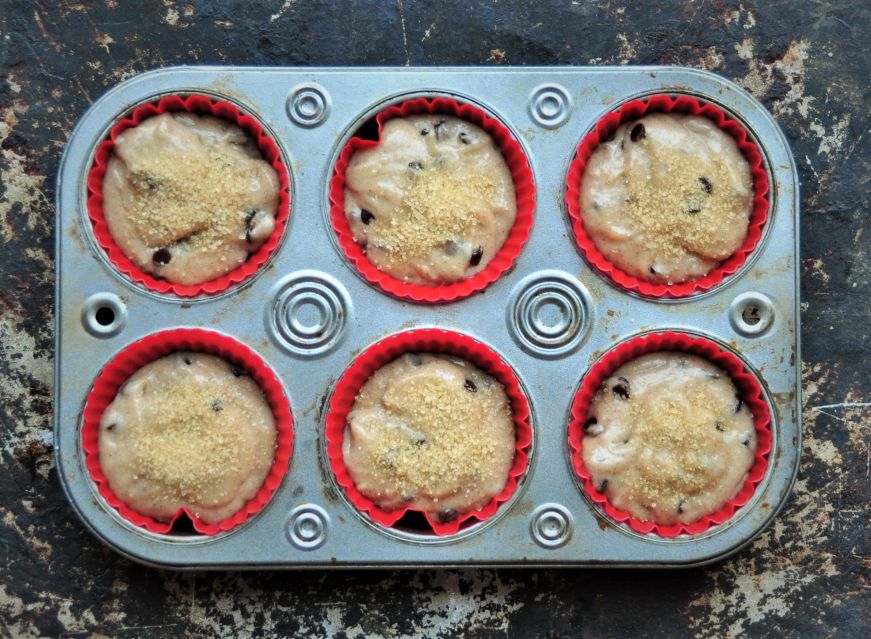 Top down view of muffin tin filled with batter