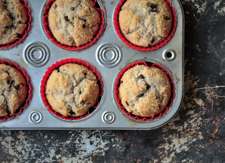 Cinnamon chocolate chip muffins in a muffin tin