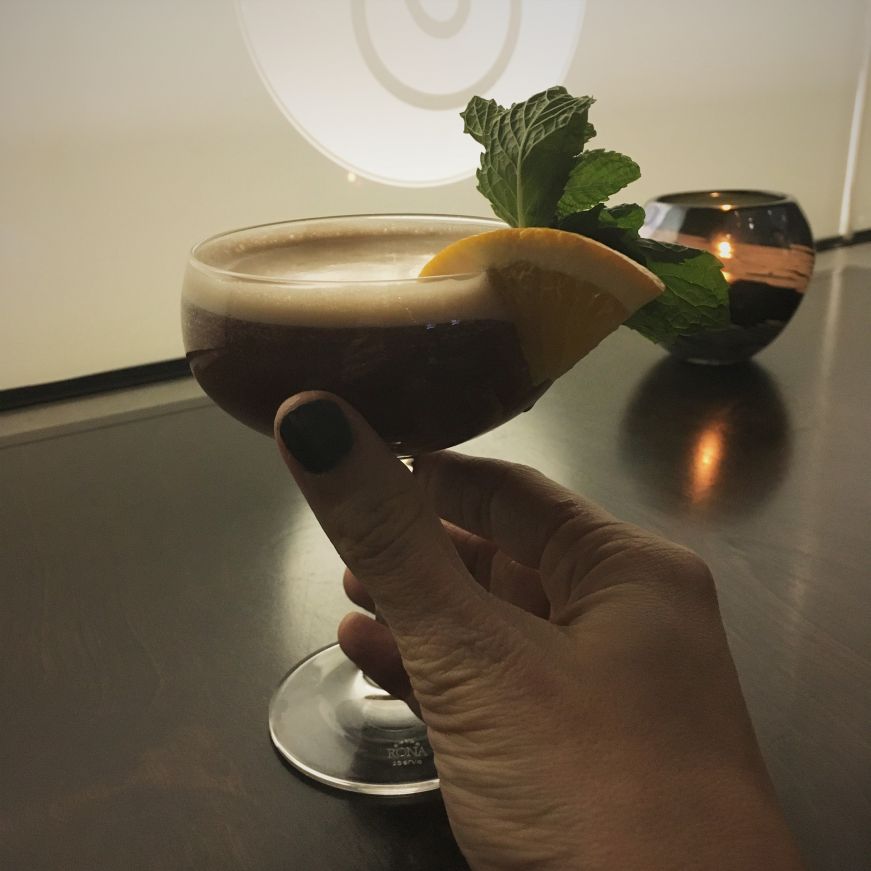 Woman's manicured hand holding a cocktail, Cedar + Stone Urban Table, Mall of America