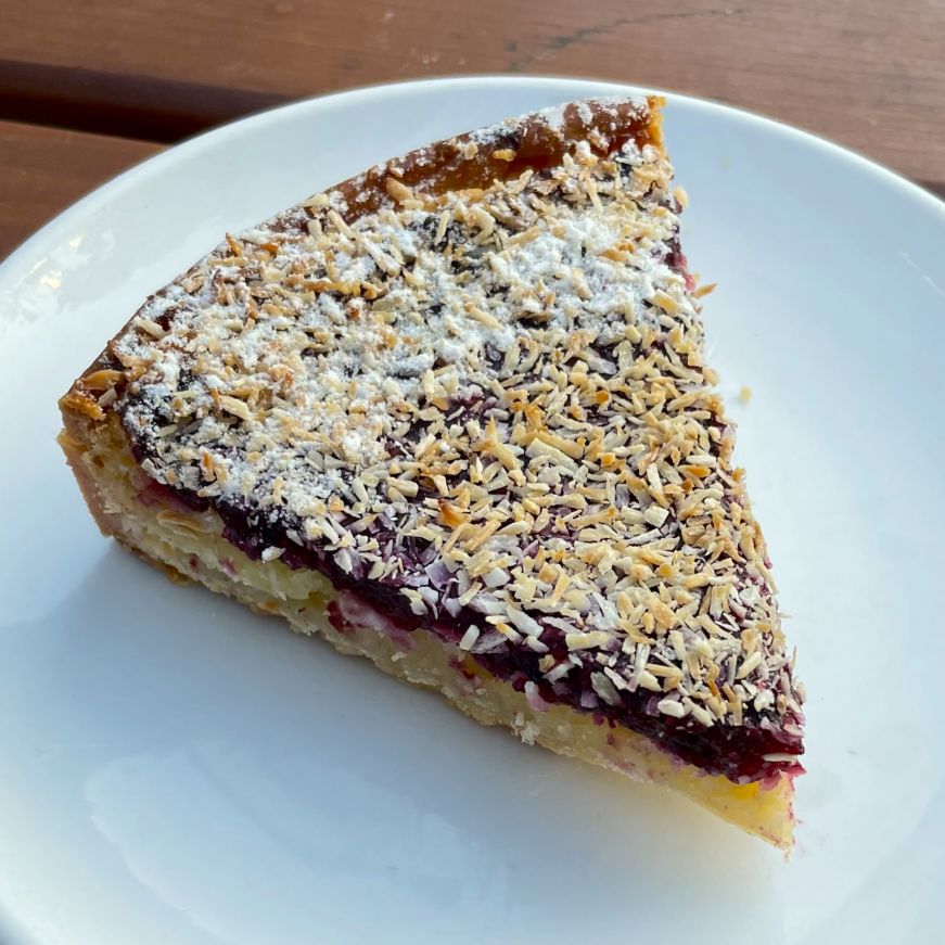 Coconut mixed berry frangipane tart, Tatte Bakery Slice of berry tart topped with toasted coconut