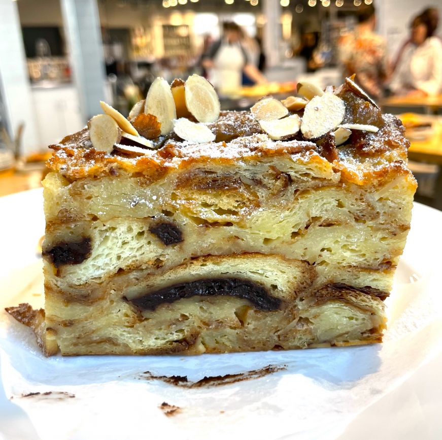 Square piece of bread pudding topped with sliced almonds