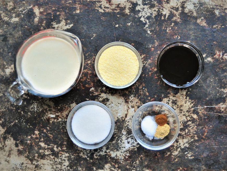 Measured ingredients for cornmeal molasses pudding
