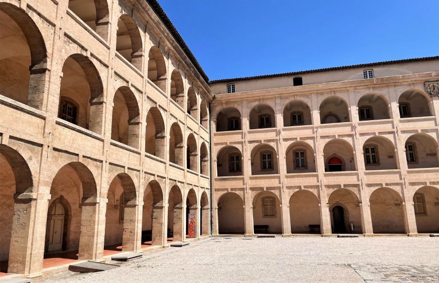 Three story building with elegant arcade walkways