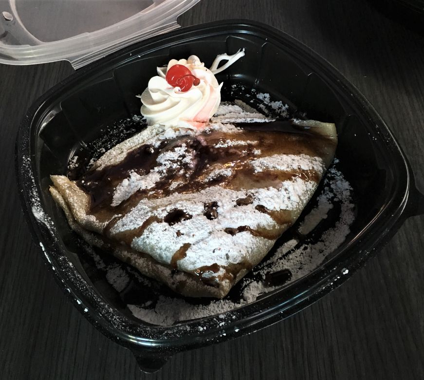 Crepes filled with bananas and drizzled with chocolate in a takeout box at Paleterias Tropicana, Kansas City