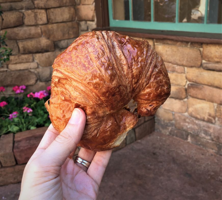 Croissant, Les Halles Boulangerie-Patisserie Hand holding croissant