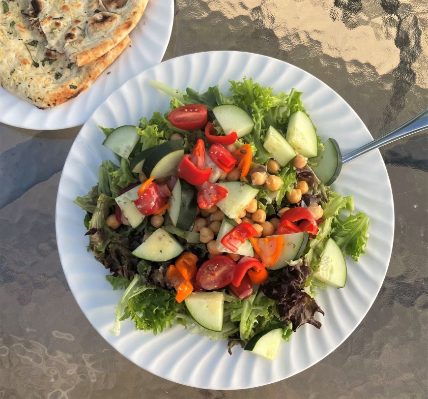 Lettuce salad topped with vegetables and chickpeas