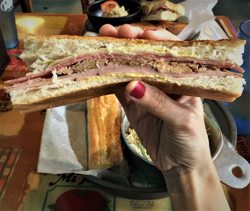 Hand holding Cuban sandwich, Stone Soup, Tampa