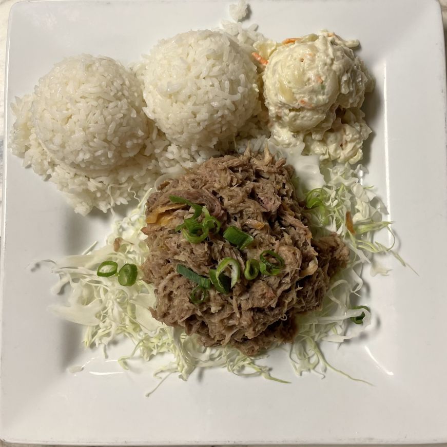 Plate with two scoops of rice, one scoop of potato macaroni salad, and kalua pork